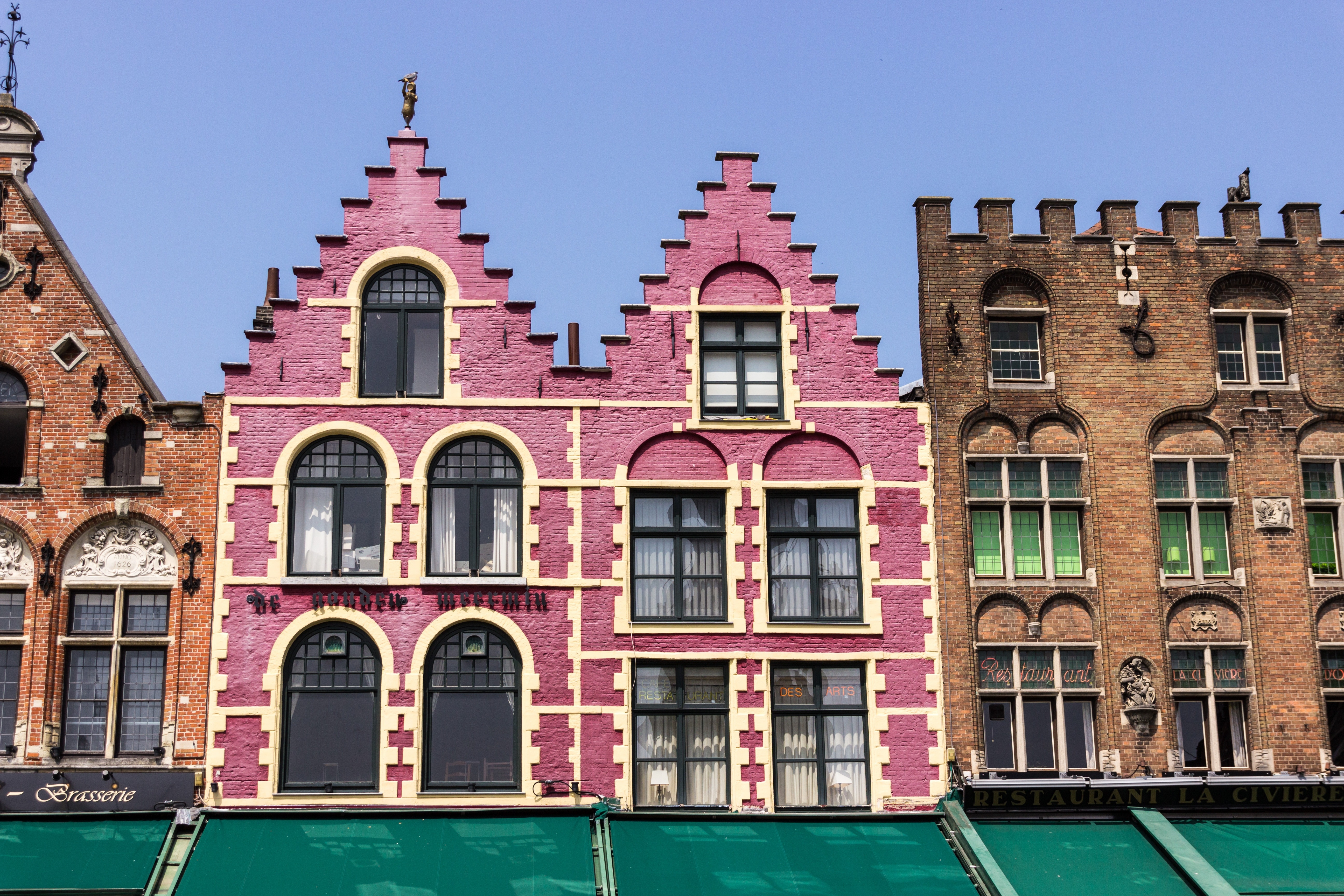 pink and white 3 storey building