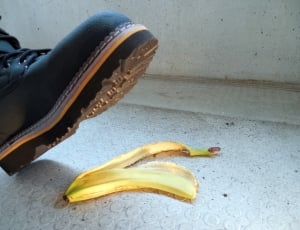 person in black shoes stepping on yellow banana peel thumbnail