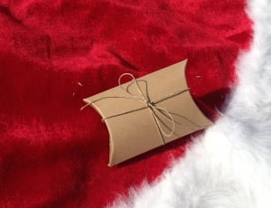 brown gift box on red textile thumbnail