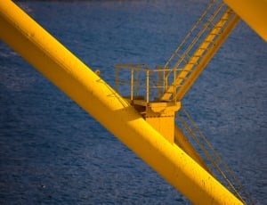 yellow steel ladder over body of water thumbnail