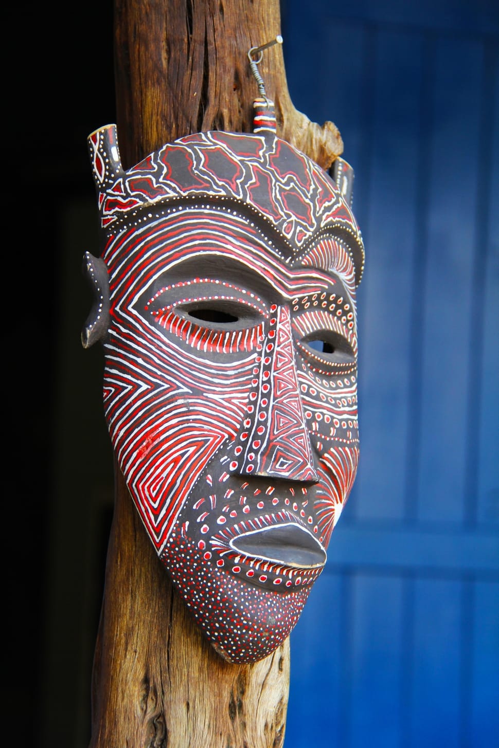 brown and red wooden mask wall decor preview
