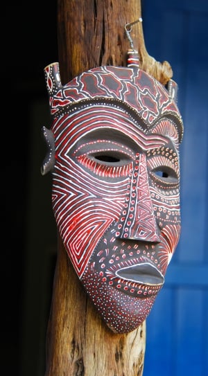 brown and red wooden mask wall decor thumbnail