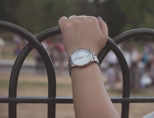 silver and white analog watch with linked strap thumbnail