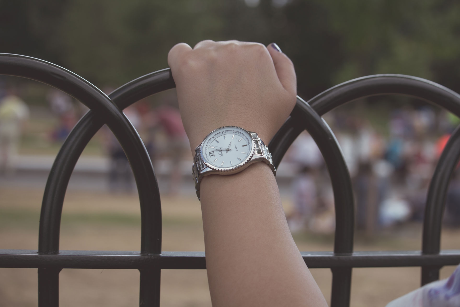 silver and white analog watch with linked strap