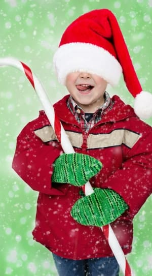 boy's red santa claus cap and candy cane thumbnail