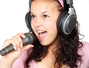 girl wearing headphones and singing using microphone thumbnail