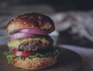 loaded burger on white wooden tray thumbnail