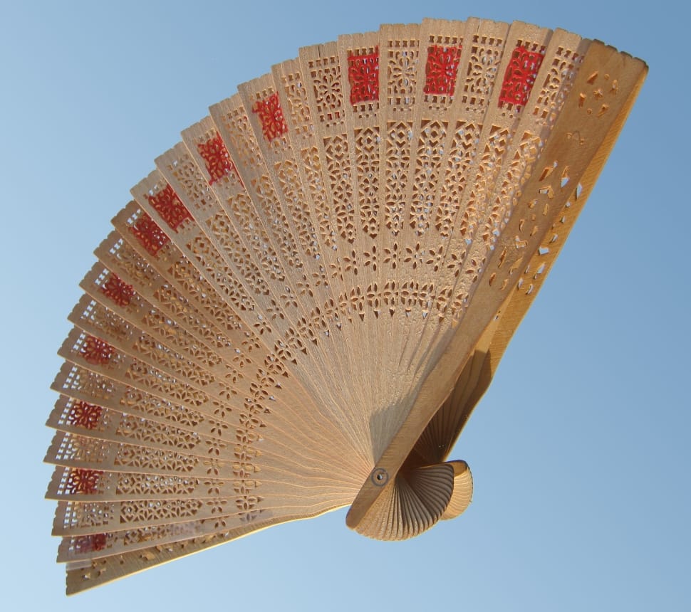 brown and red wooden hand fan preview