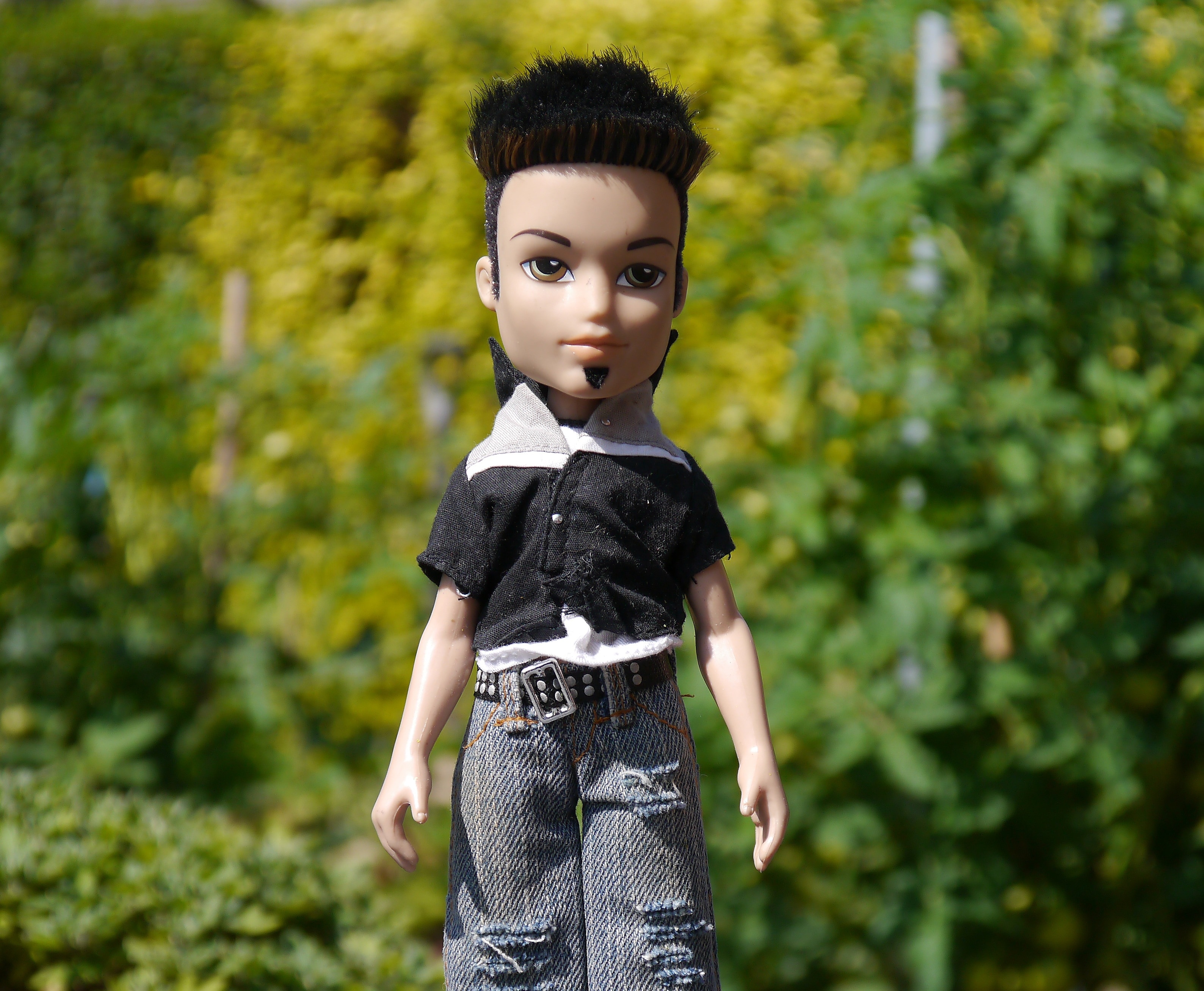 boy doll in black short sleeve shirt and blue pants