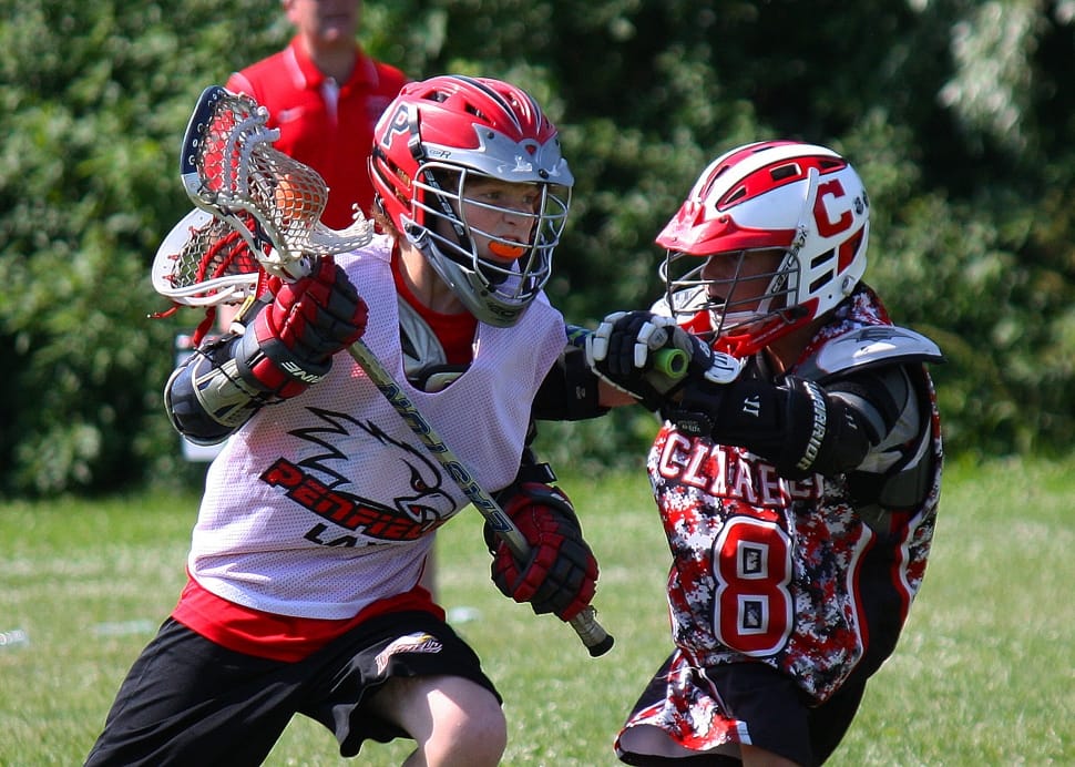 two Lacrosse player playing during daytime preview