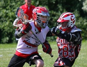 two Lacrosse player playing during daytime thumbnail