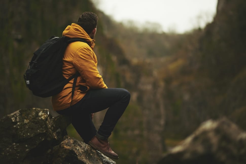 man wearing yellow hoodie and black jeans preview