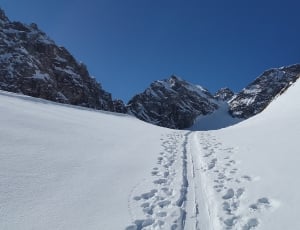 snowy mountain with human footprints thumbnail