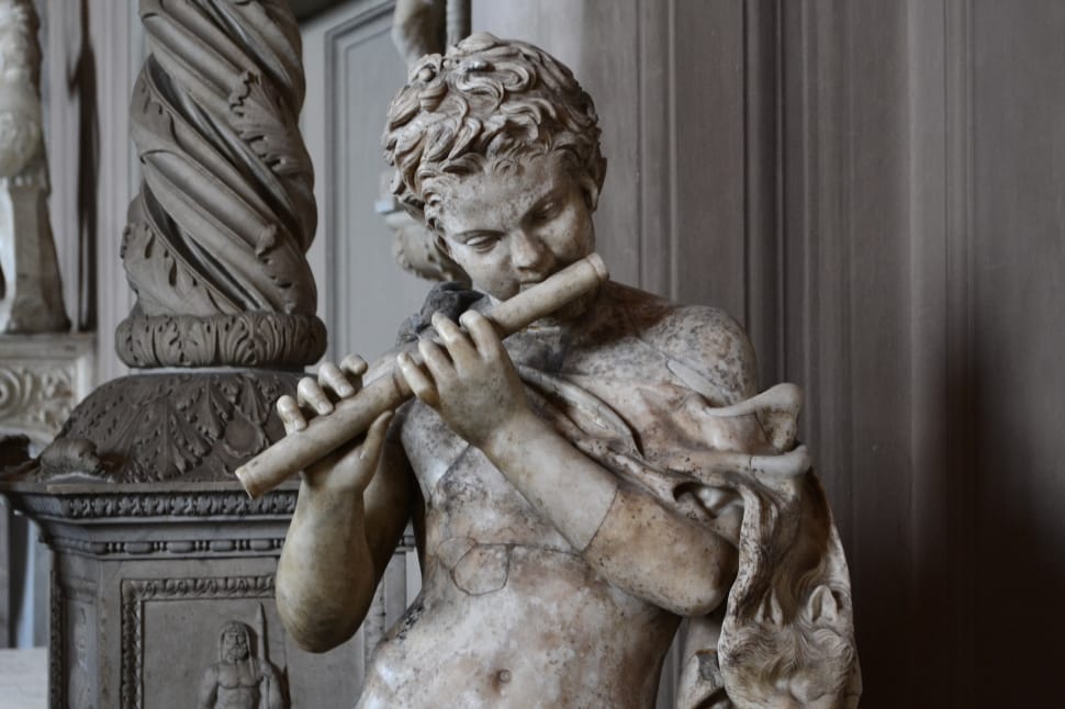 man playing flute concrete statue preview