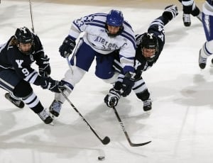 blue and white ice hockey player getting hockey puck thumbnail