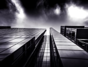 grayscale and low angle photography of high raise building thumbnail