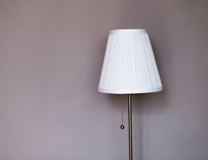 turned off floor lamp with white lampshade thumbnail