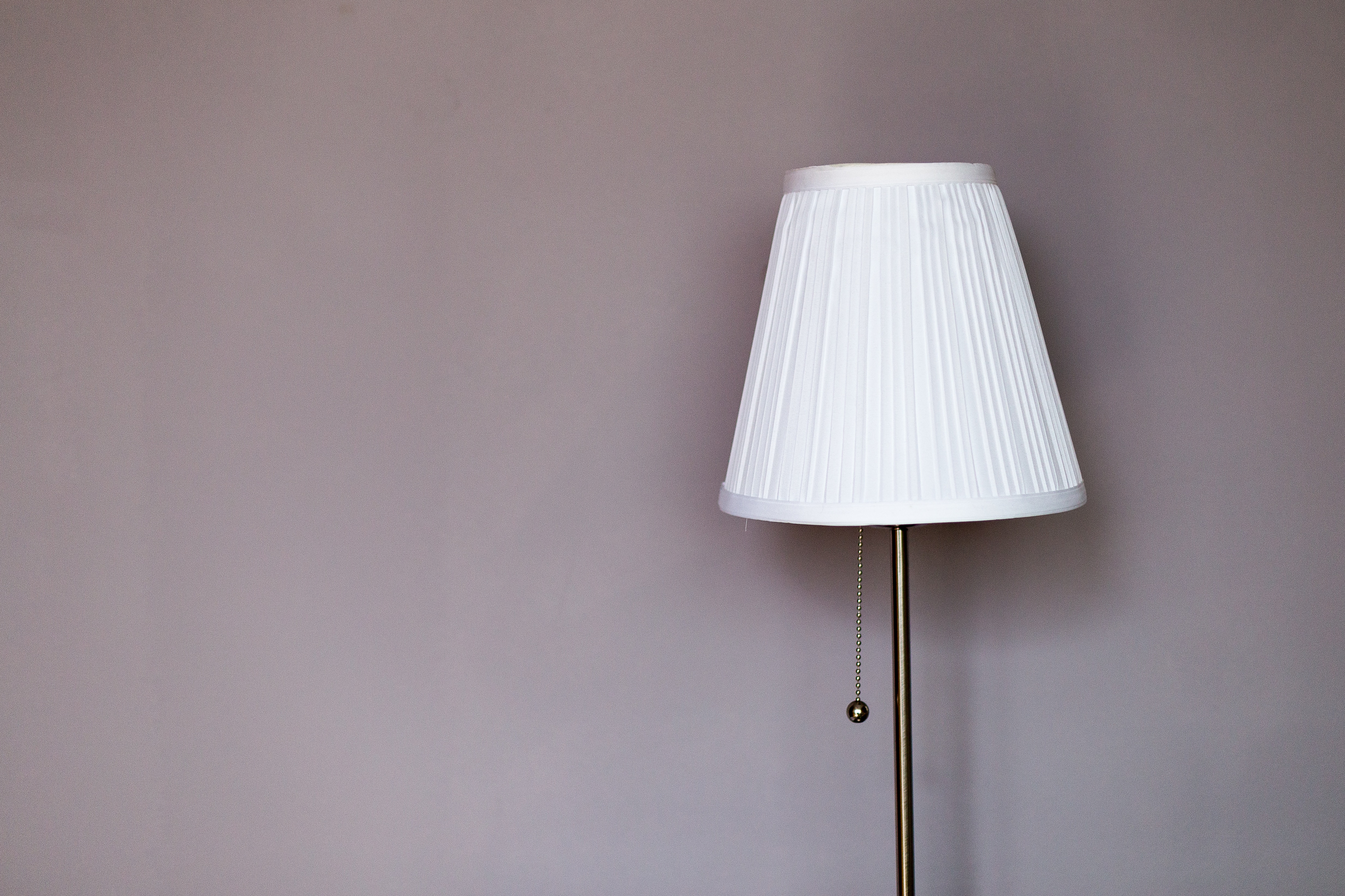 turned off floor lamp with white lampshade
