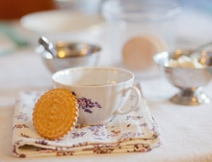 brown biscuit with white and purple floral ceramic teacup thumbnail