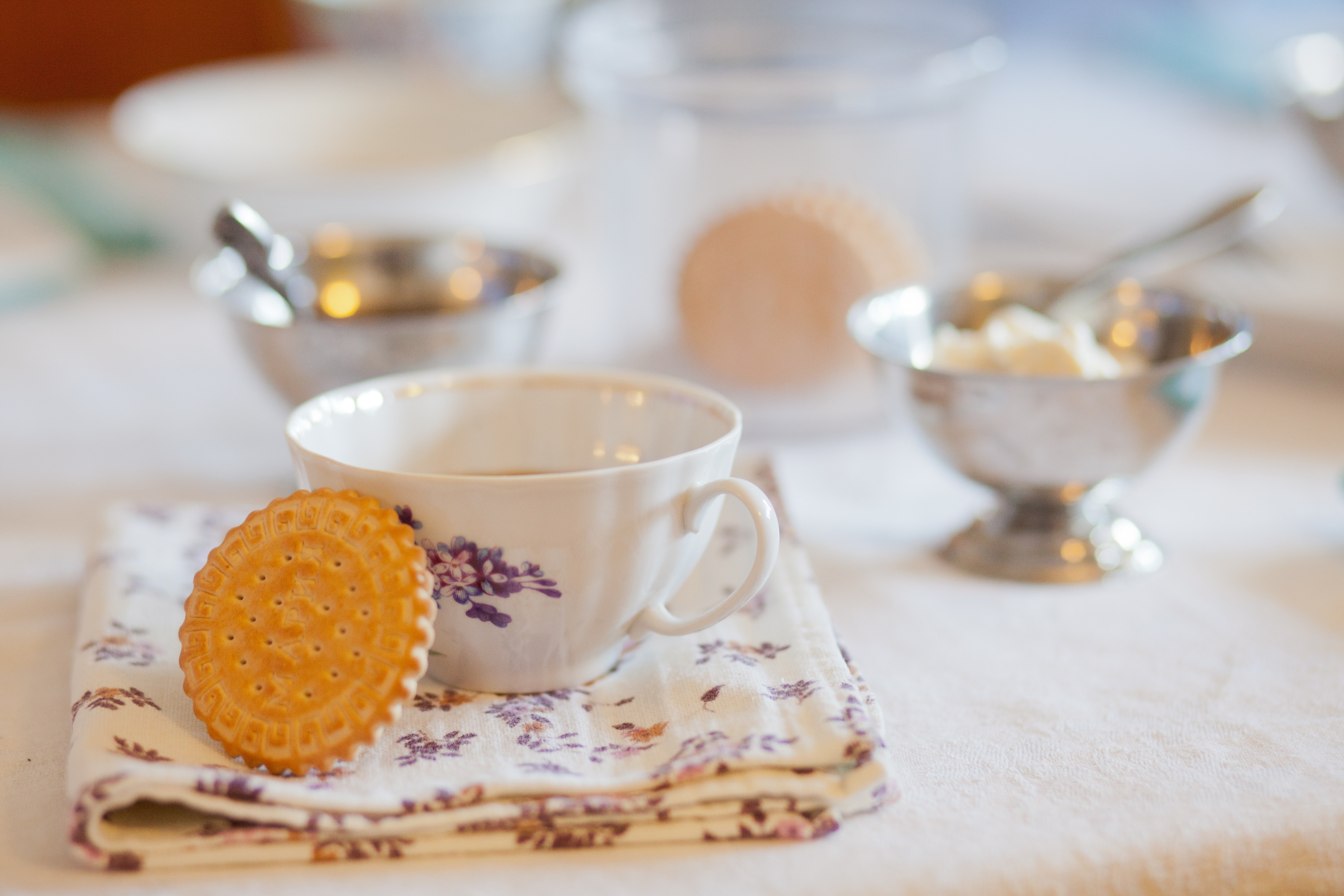 brown biscuit with white and purple floral ceramic teacup