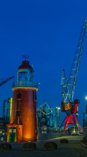 red and gray lighthouse and crane machine thumbnail