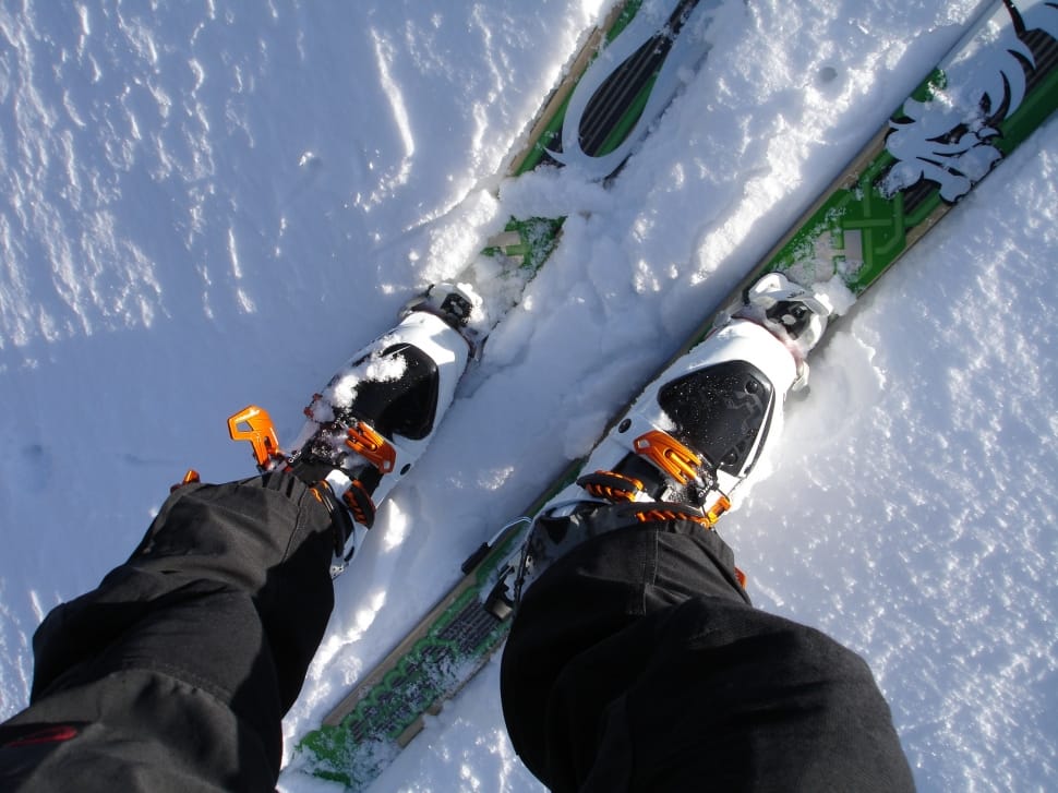 person wearing green skiblades on snow preview