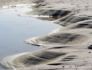 grey sand and body of water thumbnail