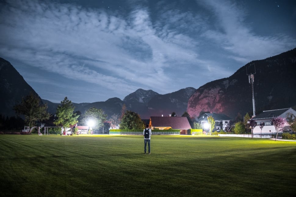 photo of man in grassland during nightime preview