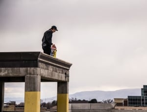 man on top of building during daytime thumbnail