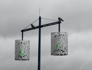 black metal post with 2 grey cylindrical lanterns thumbnail