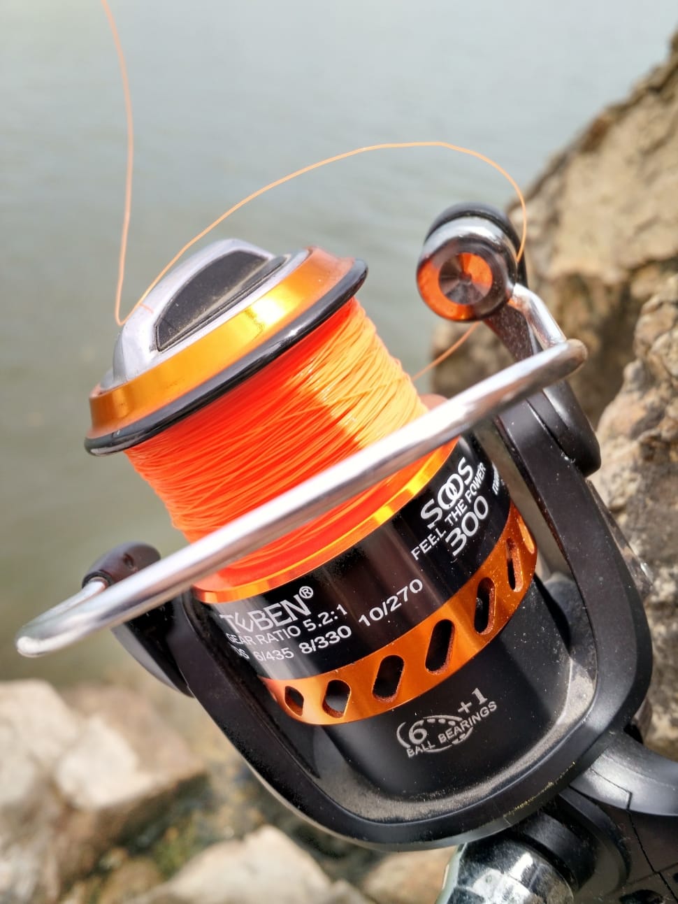 gray black and orange teben fishing reel free image