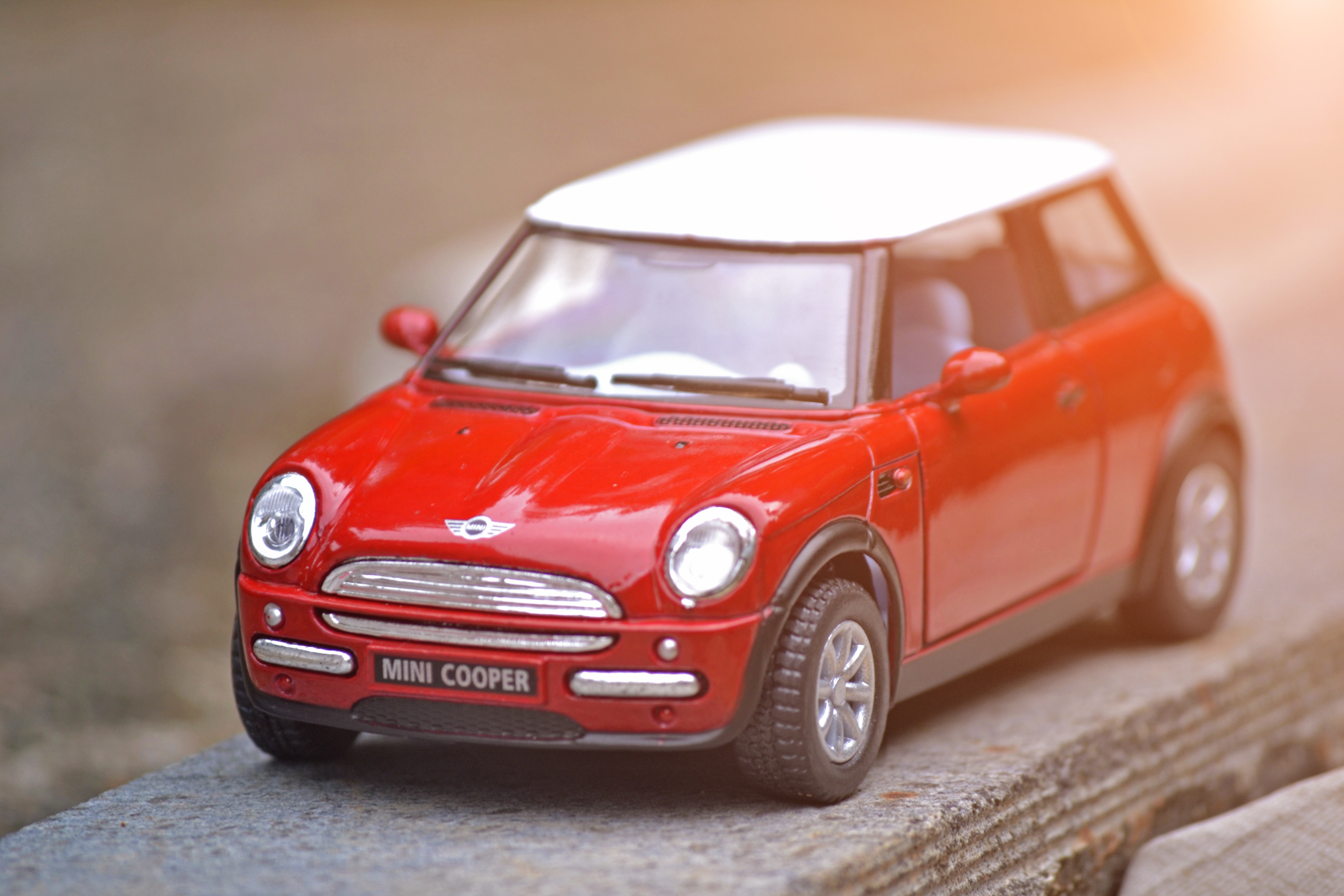 red and white die cast model mini cooper car