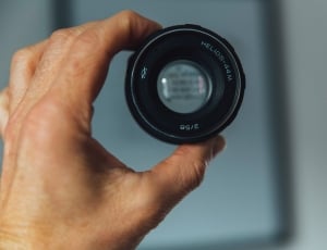 person holding a round black device thumbnail