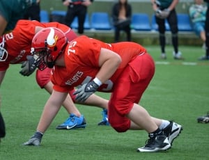 man in red football jersey playing football thumbnail