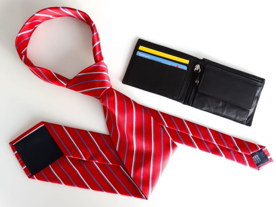 red white and purple stripe necktie and black leather bifold wallet preview