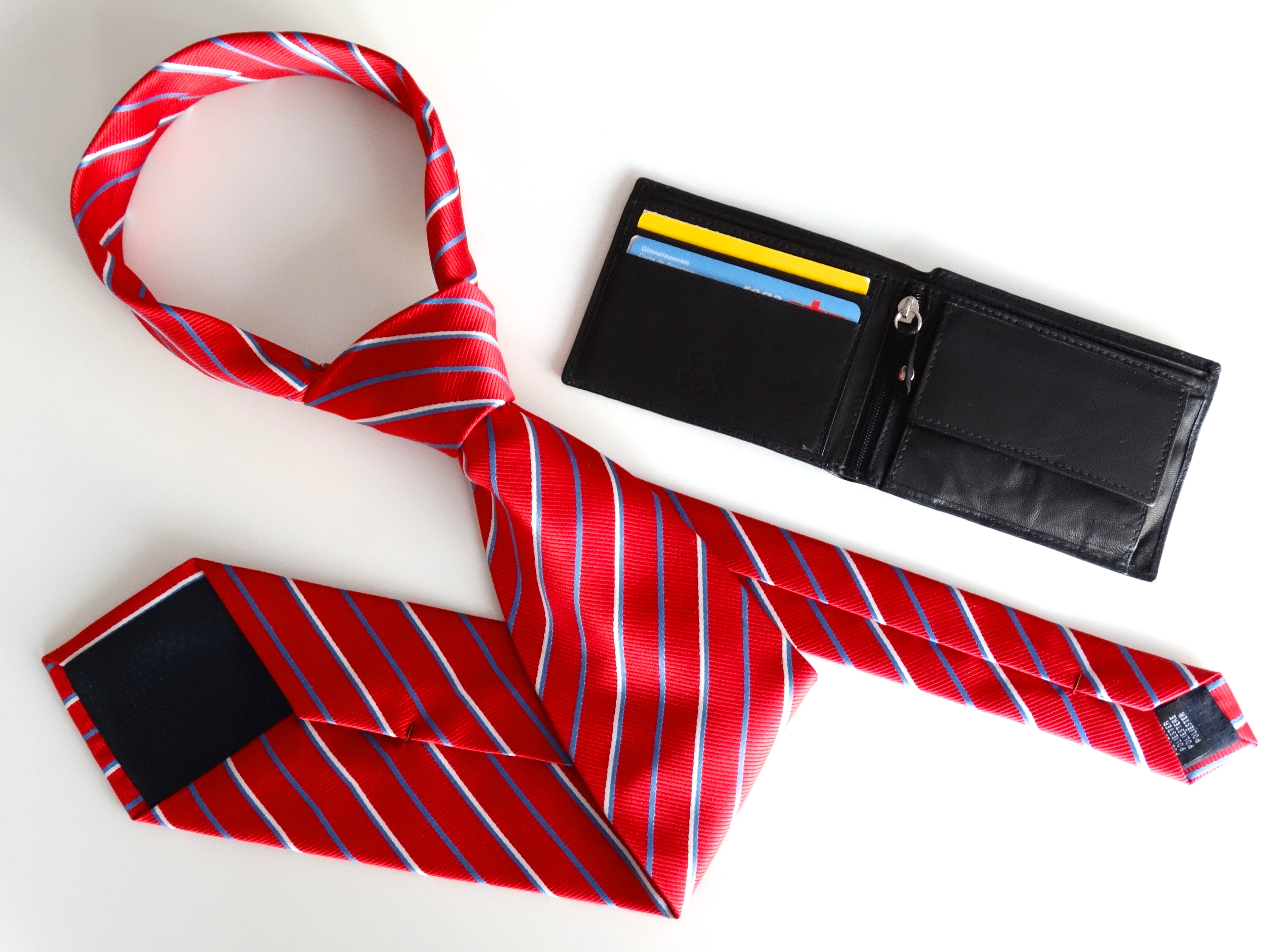 red white and purple stripe necktie and black leather bifold wallet
