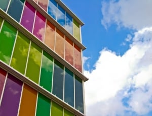 white painted with colorful window building under blue sky thumbnail