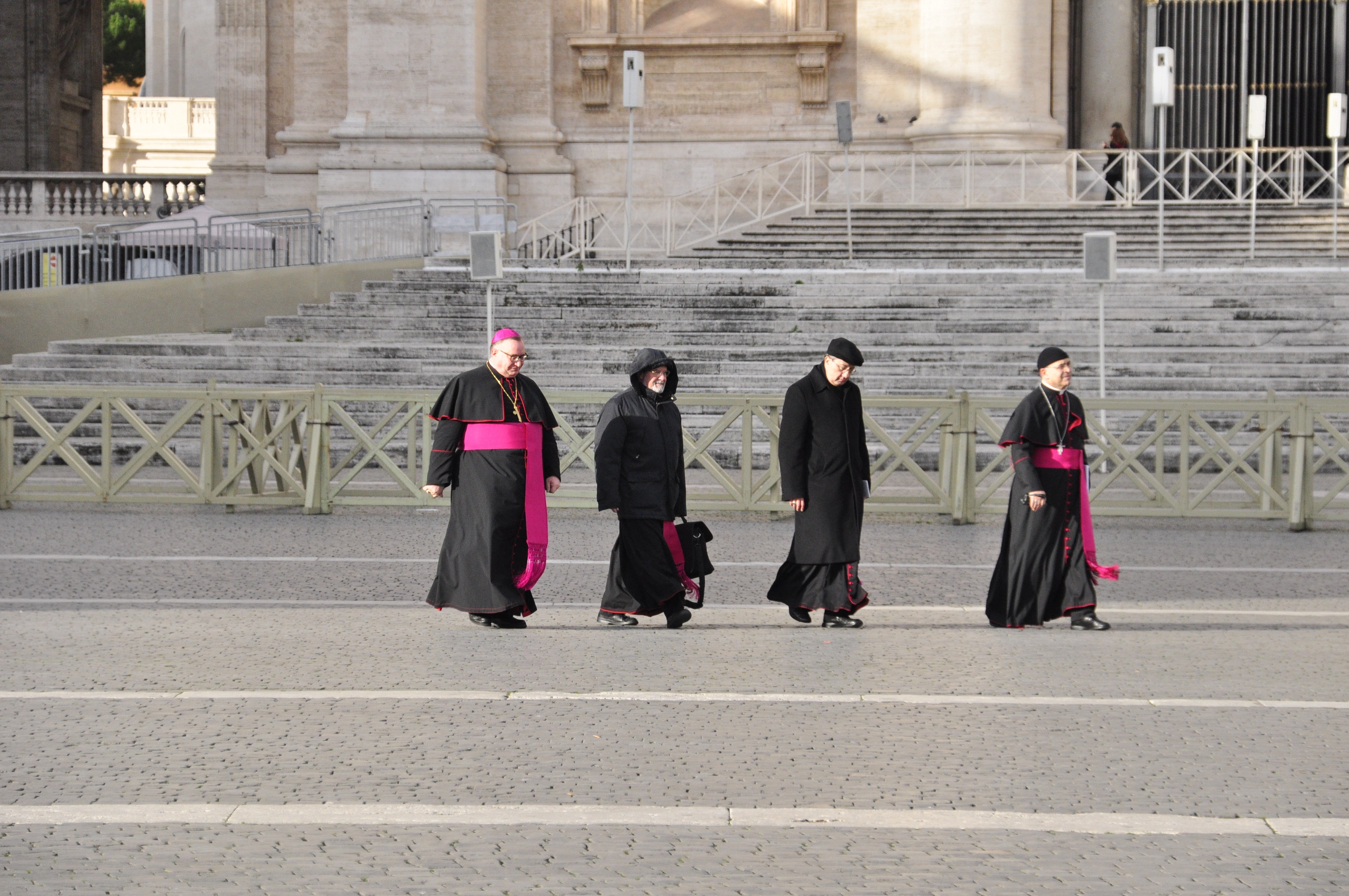 four pope walking on pathway during day time