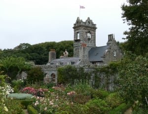 grey concrete castle with flag and flower garden thumbnail
