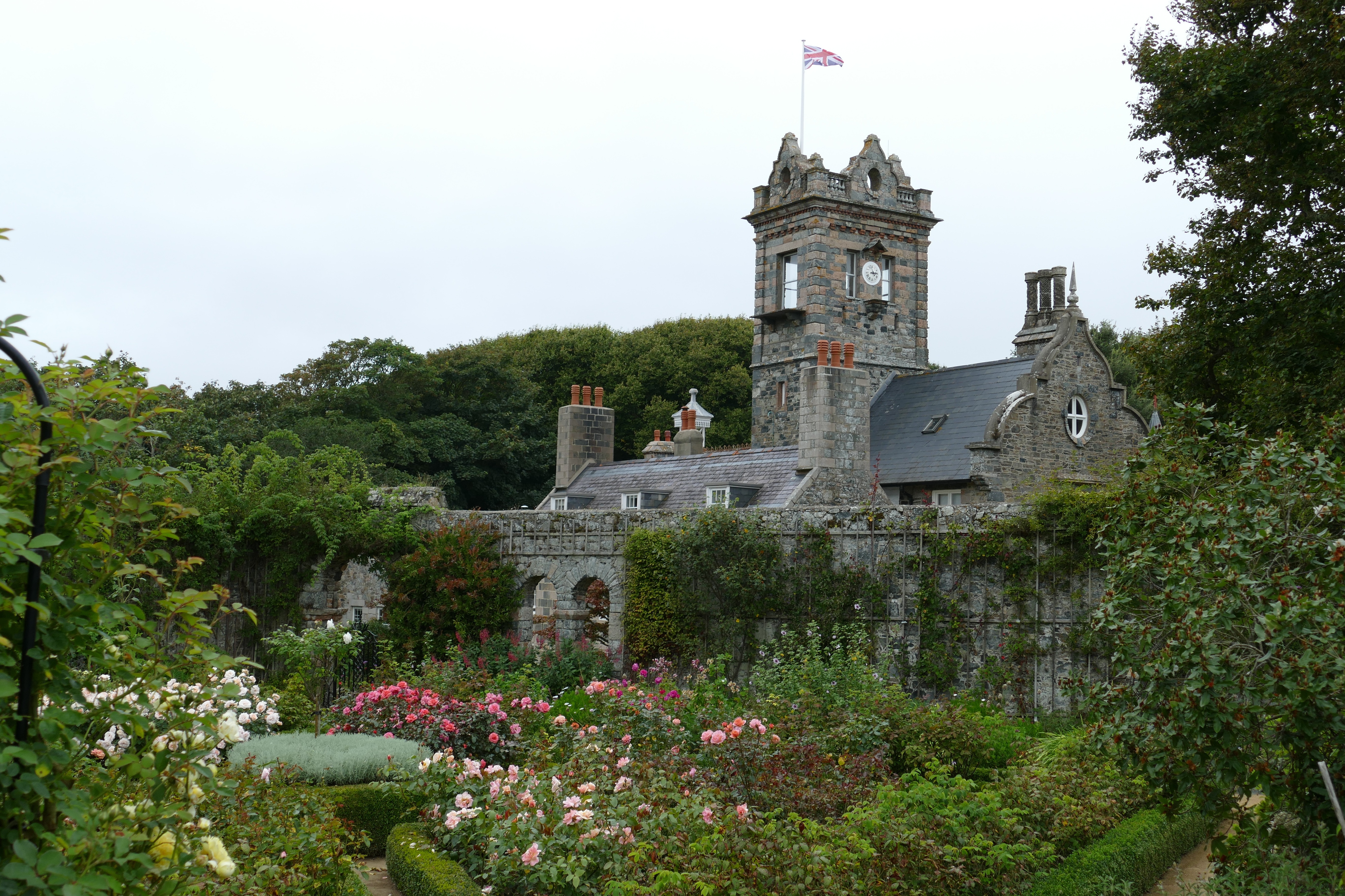 grey concrete castle with flag and flower garden