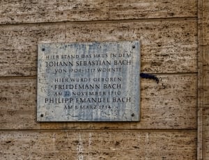 plaque on brown wall thumbnail