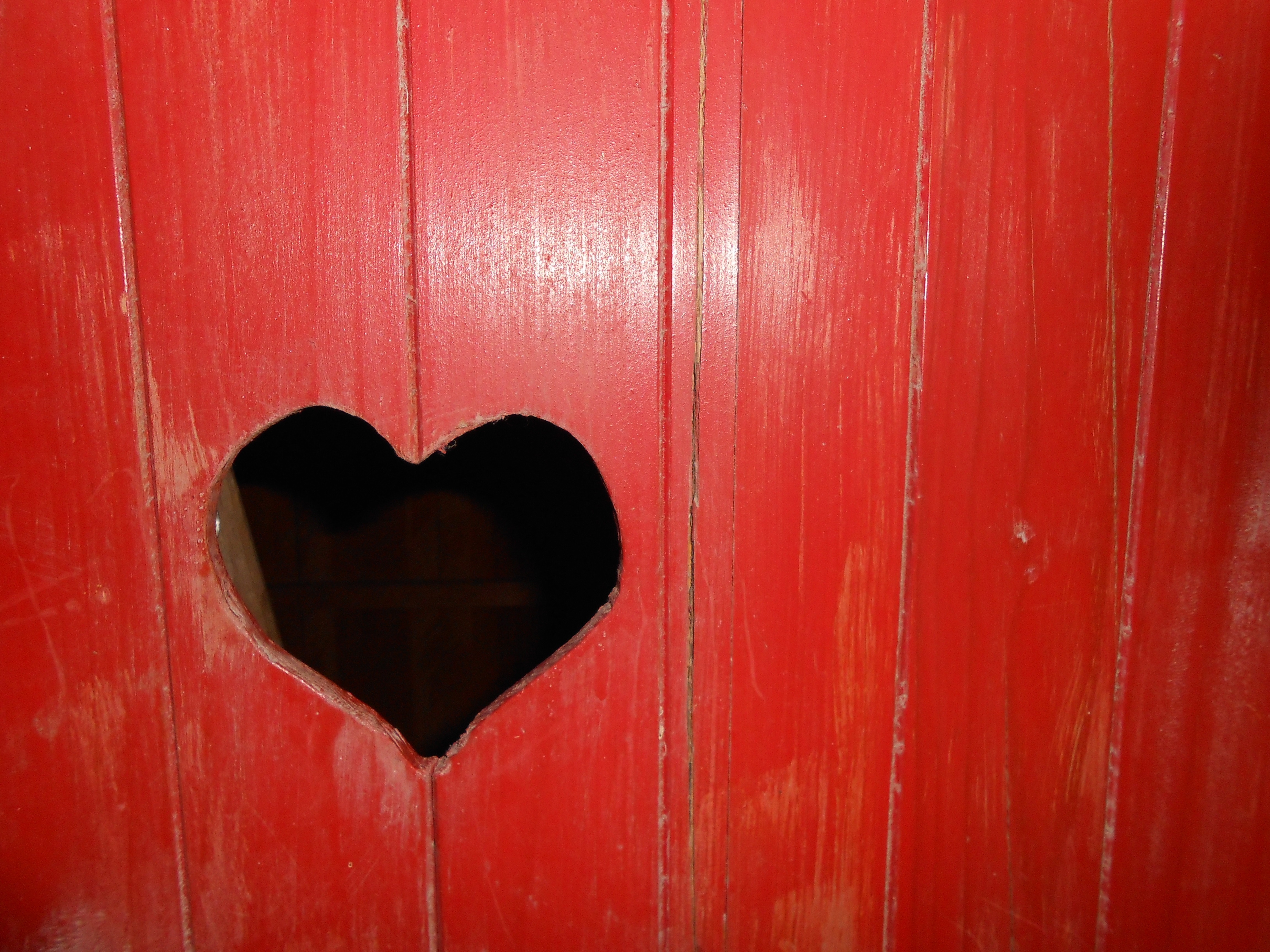 red wooden surface with heart slot