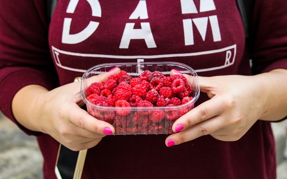 raspberries in plastic container preview