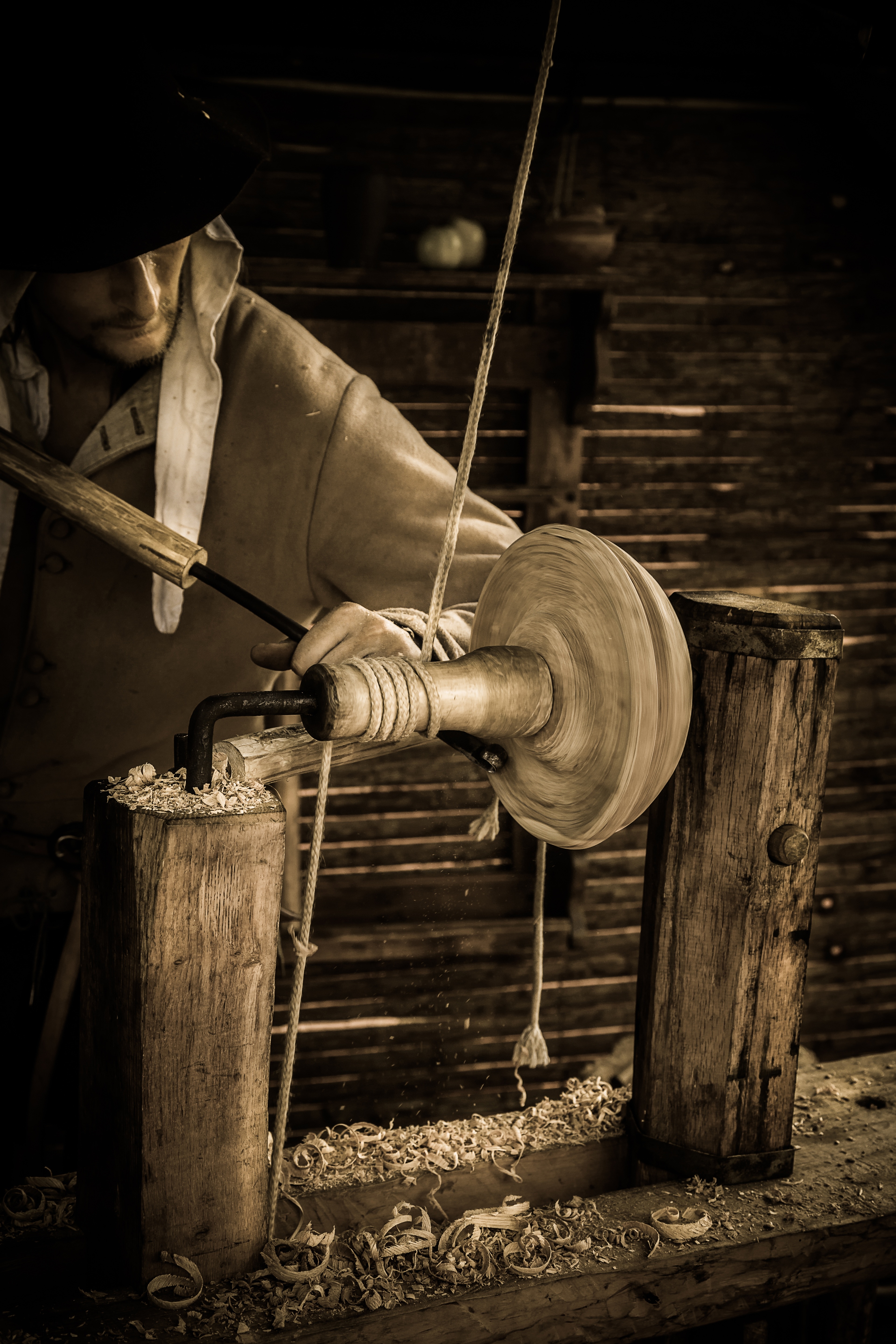 man carving wood