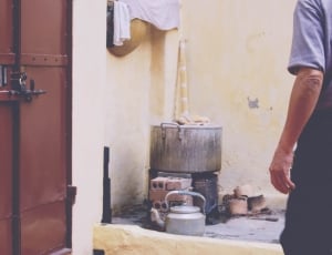 grey cooking pot near human wearing grey t shirt thumbnail