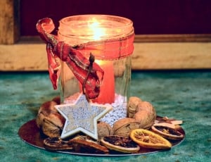 red pillar candle in glass jar thumbnail