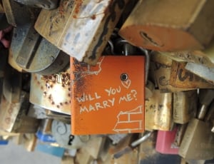 orange pad lock with will you marry me text beside lot of padlock thumbnail