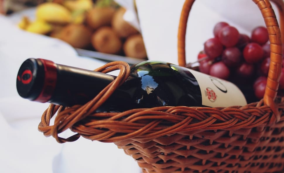 brown wicker basket with wine bottle and grape fruit preview