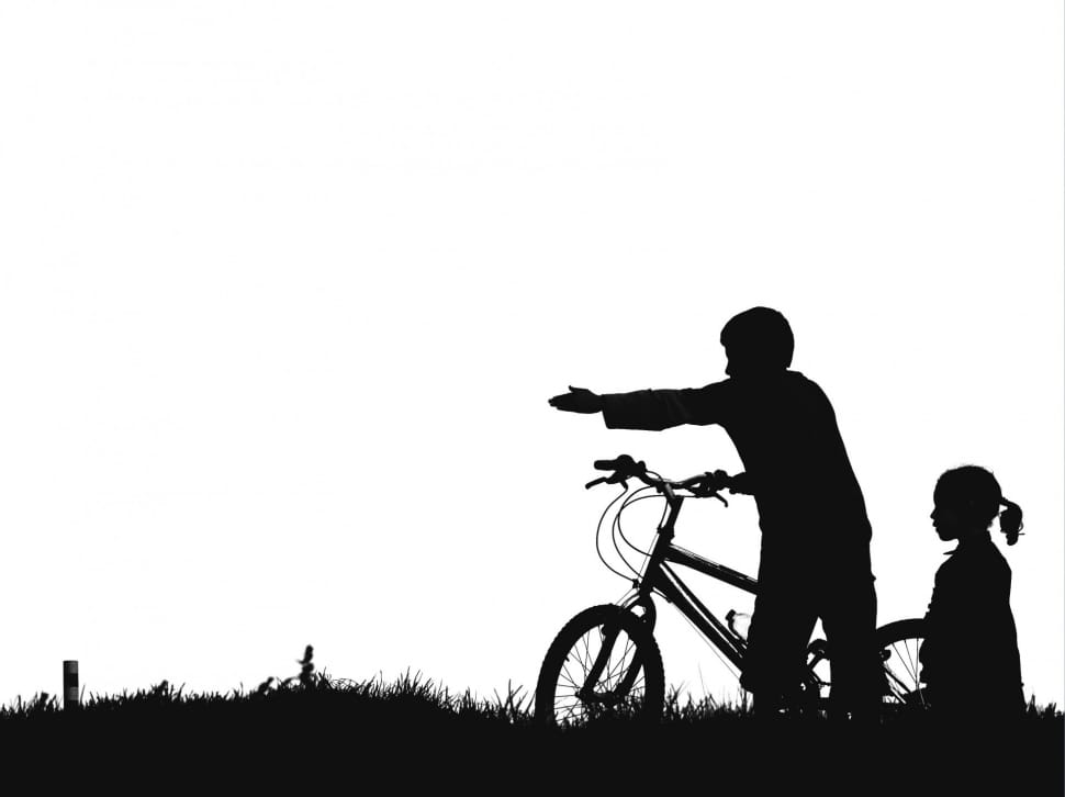 silhouette of boy and girl with bmx bike preview