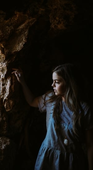 woman on blue dress wearing cameo pendant inside of the cave thumbnail